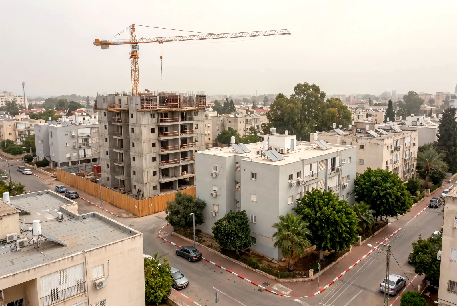 Illustration: an aerial view of a construction site with a tower crane beside older, well-kept residential buildings